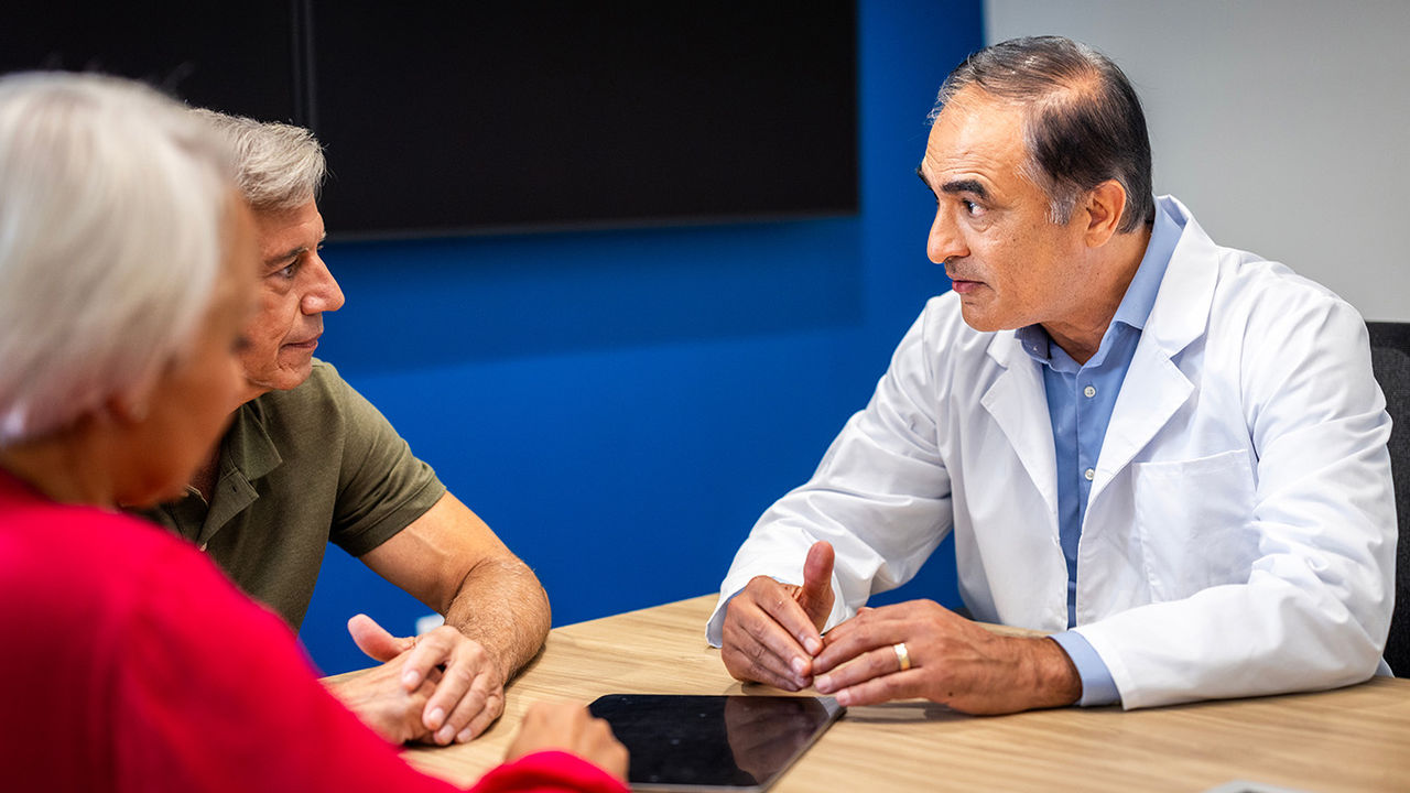 Physician consulting with patients about non-surgical treatment options for benign prostatic hyperplasia (BPH).