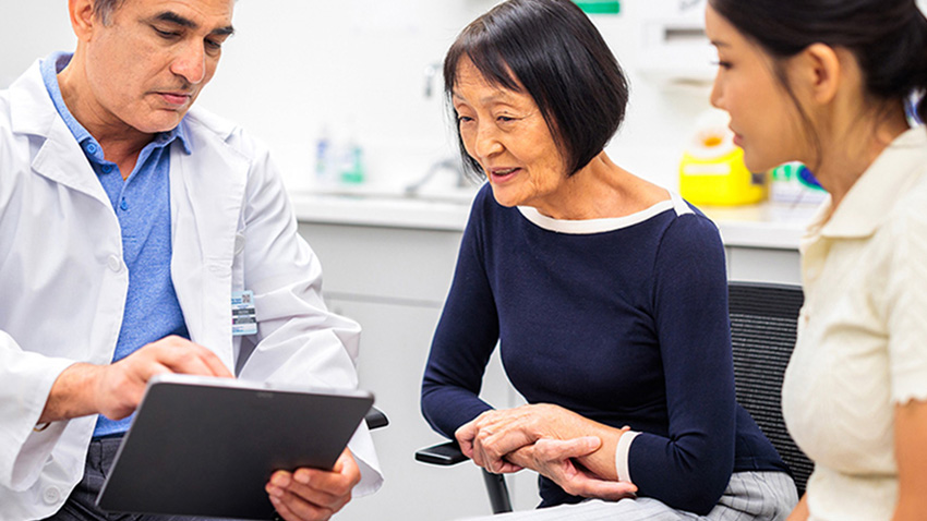 Physician reviewing stress urinary incontinence treatment options with patient.
