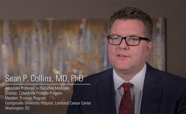 Still from video. Dr. Collins sitting in an interview setting discussing late rectal toxicity