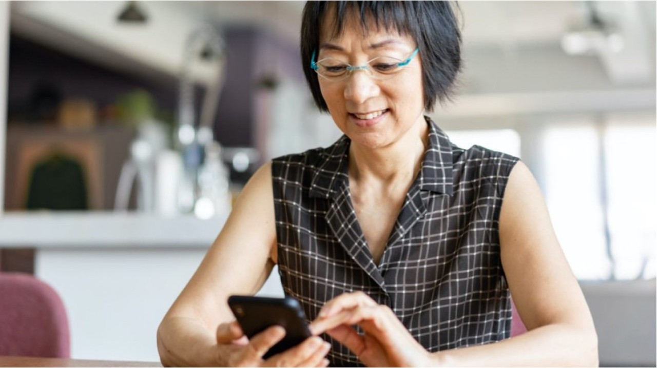 woman using mobile device with smiling face