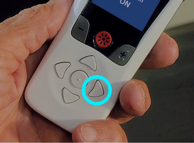 Person holding remote with the right arrow button highlighted