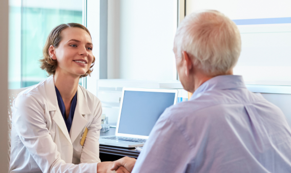 Healthcare professional talking with patient in office setting.
