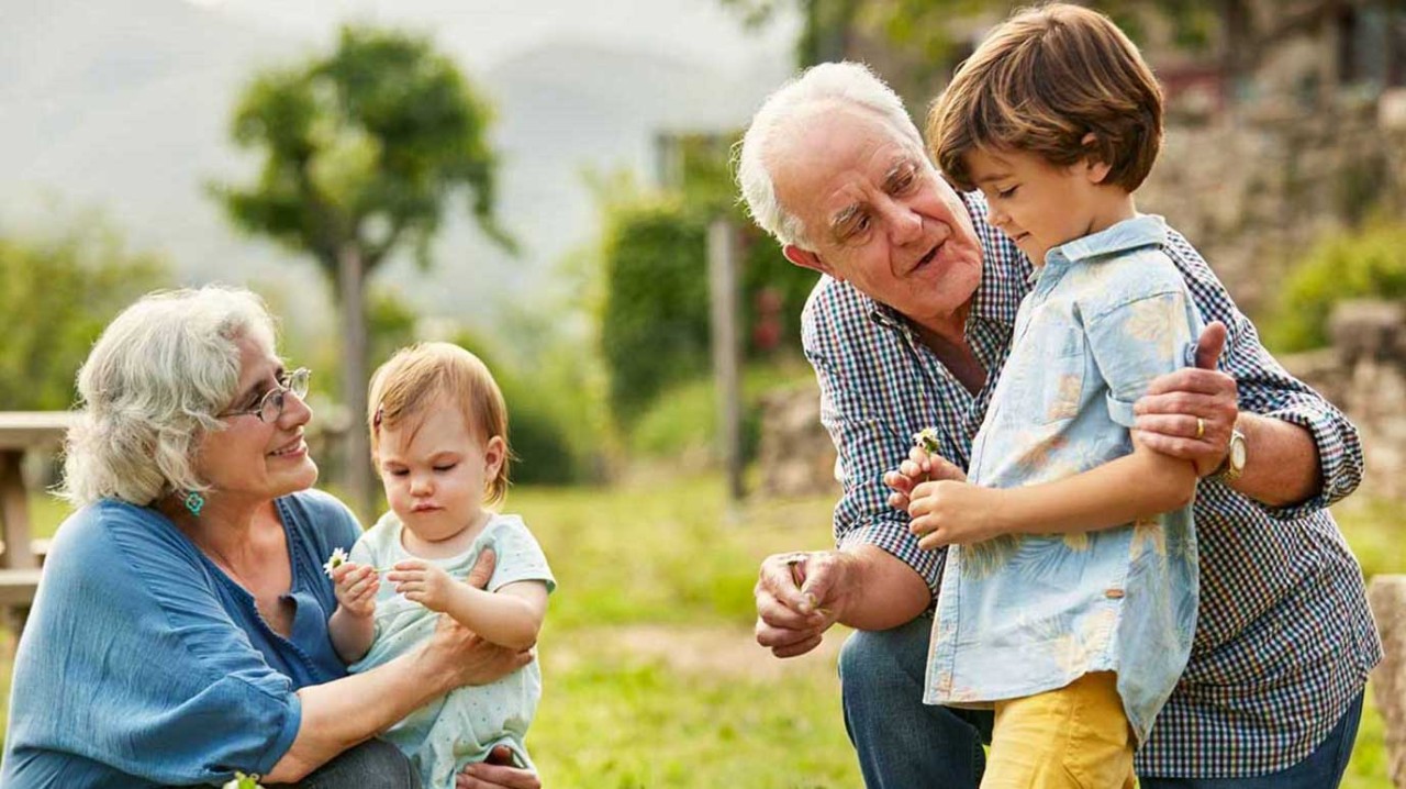 Two grandparents playing with their two grandchildren
