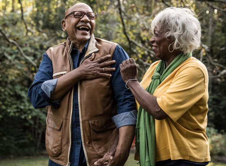 Older couple laughing in the outdoors