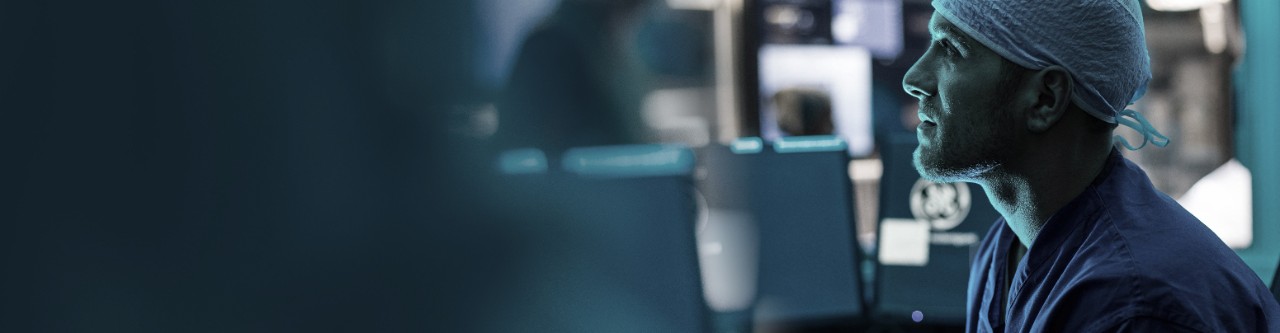 Clinician looking at screens in care setting.