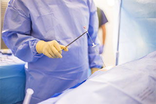 Physician Holding Needle Close